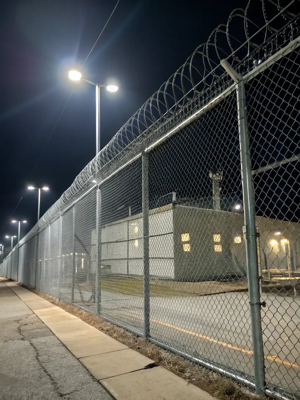 Standard Expanded Metal used in a security fence around a property, demonstrating its strength and effectiveness in deterring unauthorized access.