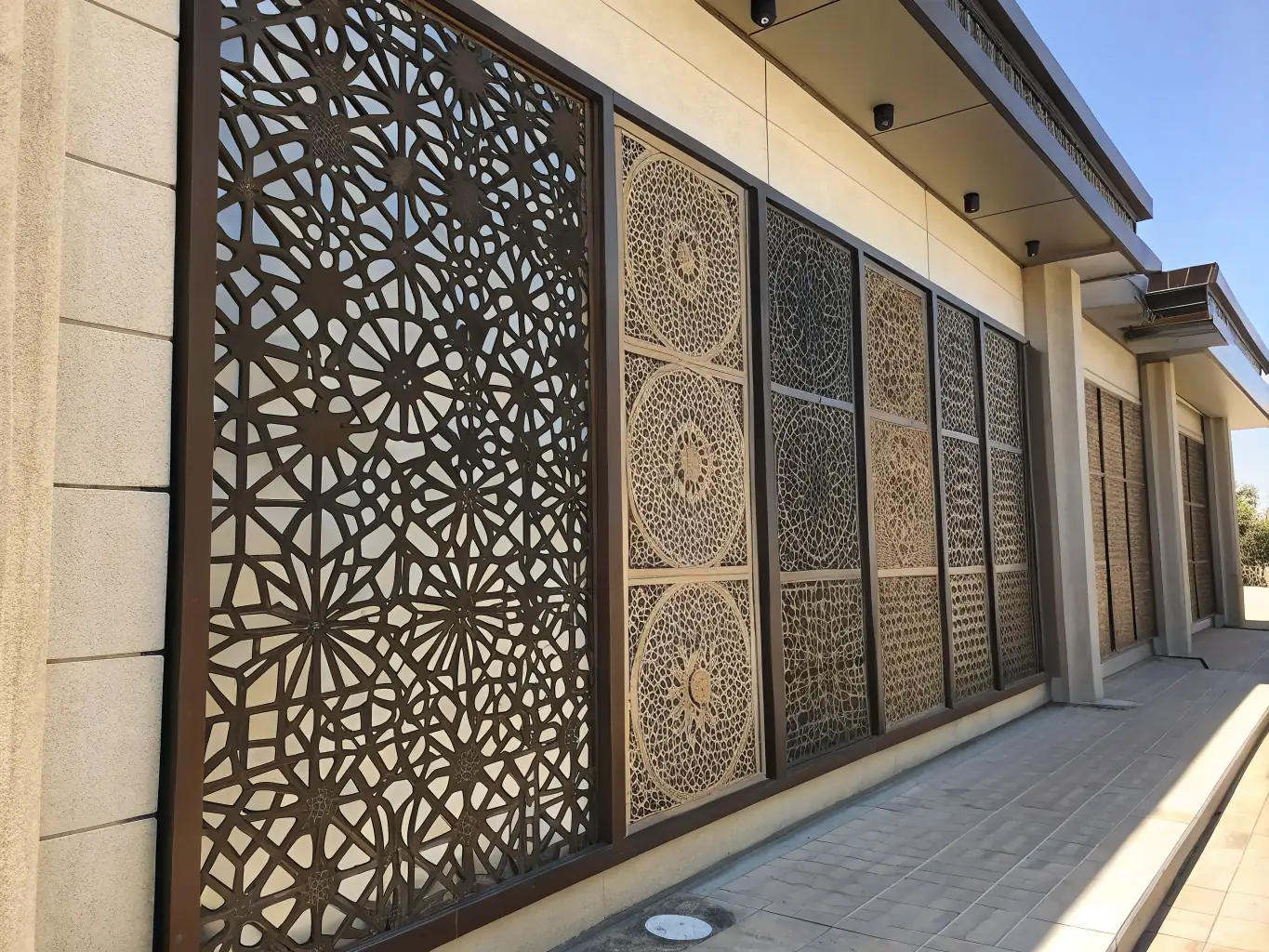 An image displaying decorative wire mesh panels installed in a modern building facade, showcasing their intricate patterns and visual appeal.