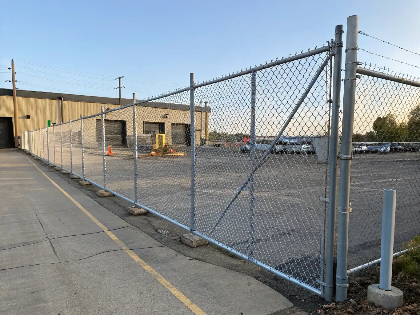 An image of an aluminum chain link fence installed around a commercial property, emphasizing its lightweight nature and resistance to rust. The fence blends seamlessly with the surrounding landscape.