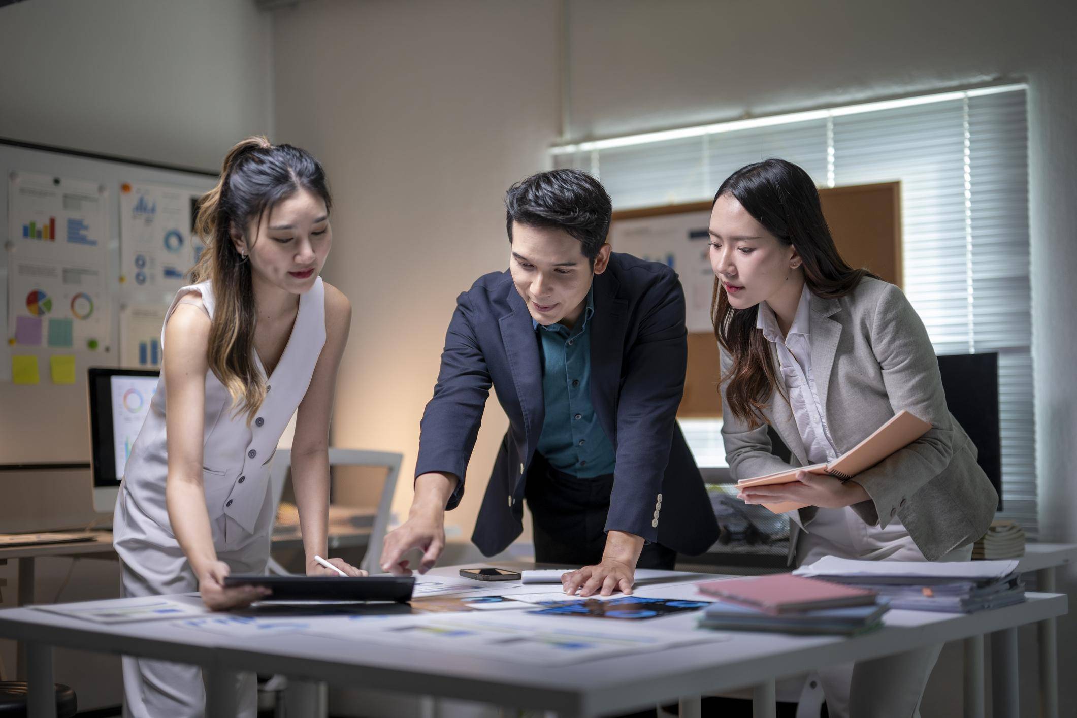 Asian business team collaborating on business strategy in office
