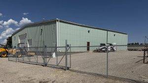 Chain link fence protecting farm equipment storage area(1)