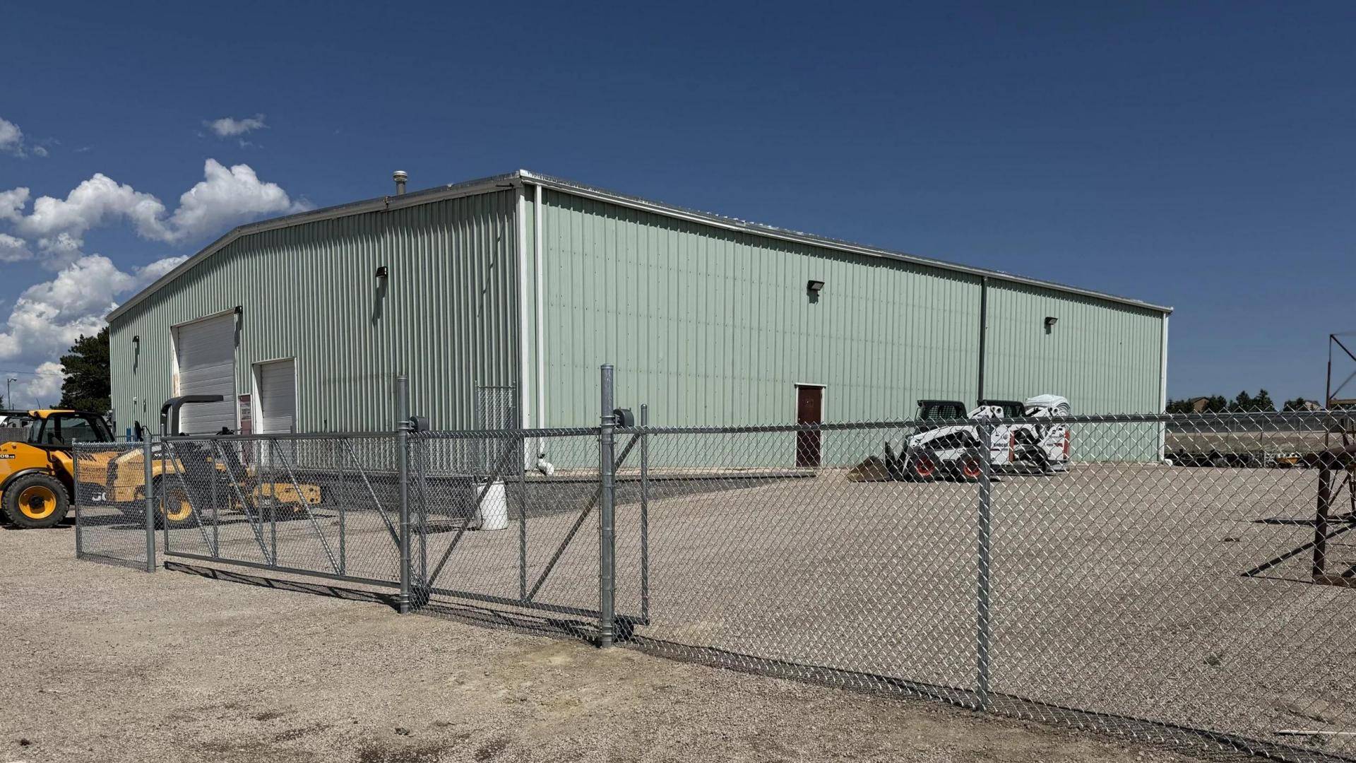Chain link fence protecting farm equipment storage area(1)