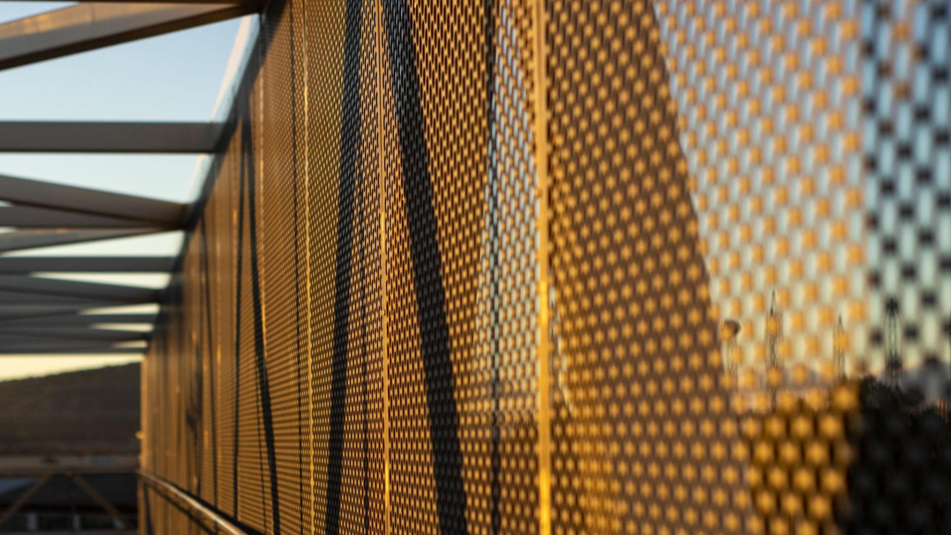 aluminum composite panels or cladding with perforated sheets on modern building facade on sunset- Abstract architecture background concept (1)