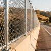 long-distance highway protected by galvanized chain link fence