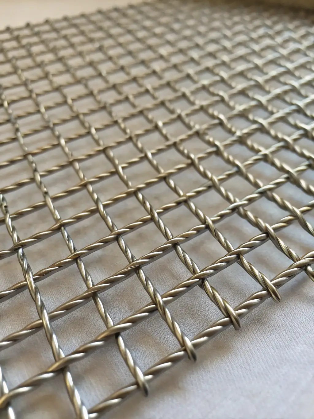 Macro shot of wire mesh with a ruler, clearly displaying mesh count per inch and precise wire spacing, suitable for technical specification illustration on a manufacturer’s website.