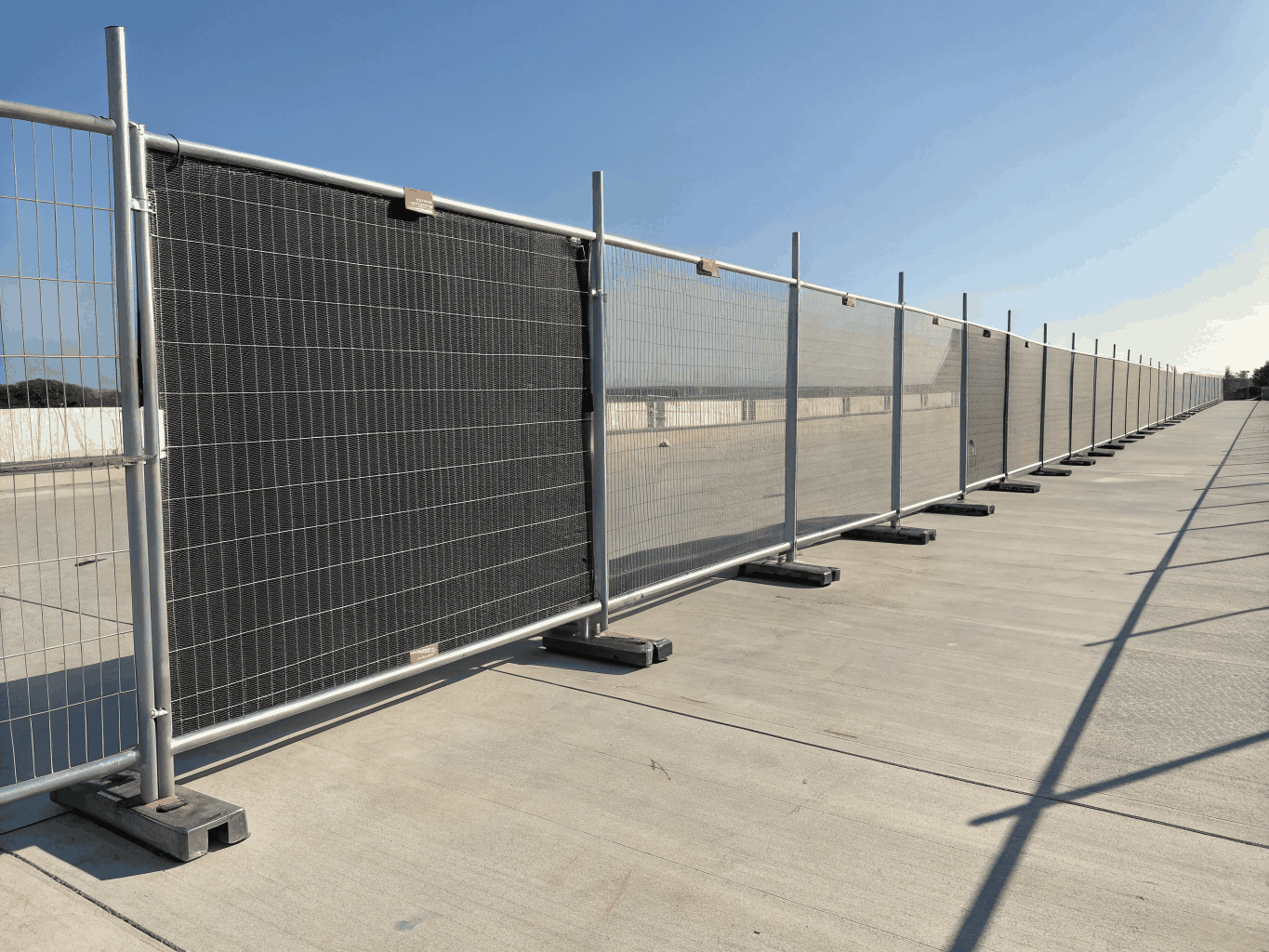 Heavy security fencing and protective metal enclosures for utility substations