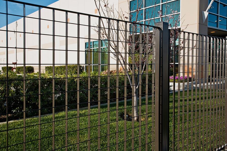 Heavy security fencing and protective metal enclosures for utility substations